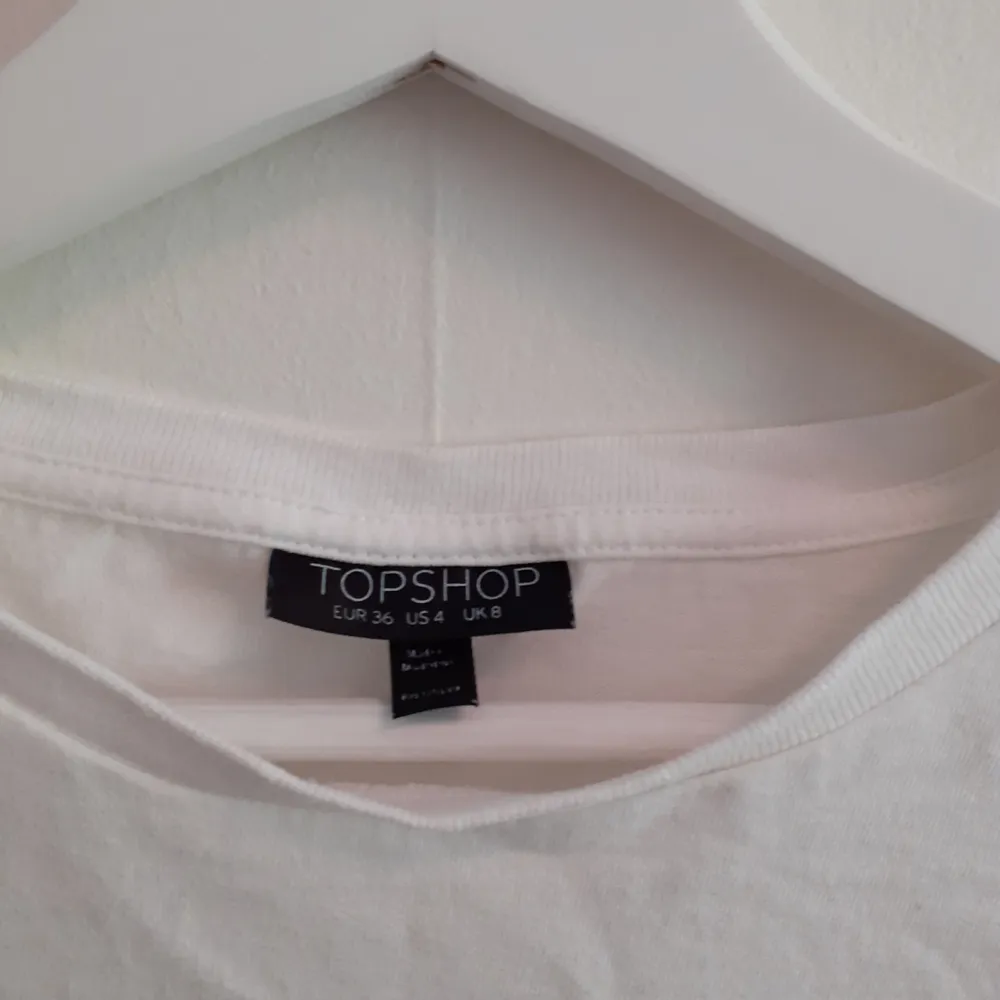 En vit croppad t-shirt från Topshop som sitter lite större under brösten. Frakt ingår i priset💋. T-shirts.