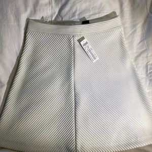 Vit ny kjol - Helt ny, endast testad från Lindex. Tappat kvittot. Vit klockad kjol i tjockt material. Storlek XS.  😊   Priset är exklusive frakt. Rensar garderoben inför flytt så finns mycket kläder uppe till en billig peng. Kan sänka priset om du köper flera plagg.💘 