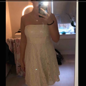  - Fin klänning som passar nu till student eller skolavslutningar, den är vit med blommigt spets på. Köparen står för frakt:)