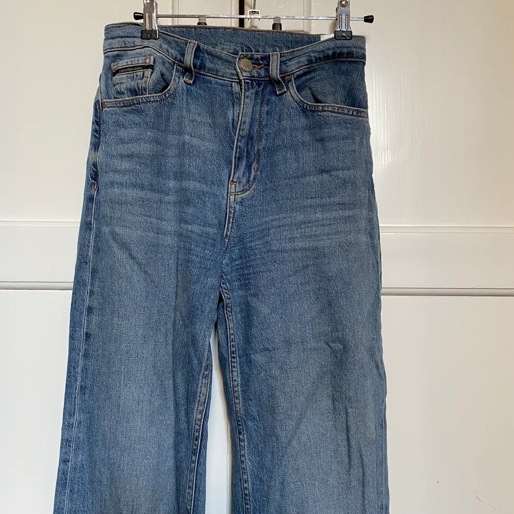 Ett par snygga Wide leg jeans från Calvin Klein i bra skick. Jag är 1,65 och de är perfekta för mig i både längd och storlek (25). Brukar vanligtvis ha 36 i allt men dessa jeans i 25 passar bra.  . Jeans & Byxor.