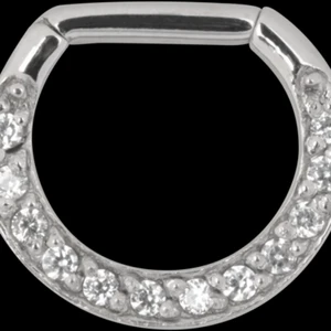 Oanvänd septum piercing med rosa stenar - Säljer en oanvänd Septum piercing med clicker. Ca 1 cm lång. Piercingen ser ut som denna på bilden, men har ljusrosa stenar. 