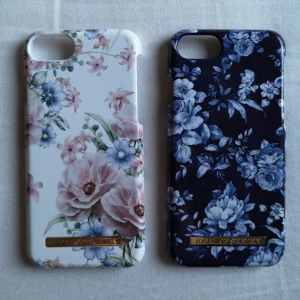  - Säljer två mobilskal till Iphone 6/6s  från Ideal of Sweden (magnetiska) , pga ny telefon. Använda fåtal gånger. Lite repor finns, men inget som stör. Det vita skalet har ett litet stenskott i ena hörnet (se bild 2). Båda skalen är köpta för nypris i butik.