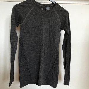 Träningströja - Träningströja från H&M som jag köpte för något år sedan. Den är använd men inte speciellt mycket och är i väldigt bra skick. Tröjan har långa armar med hål för tummarna och tunnare tyg längs sidorna och i ryggen. Orginalpris 200 kr