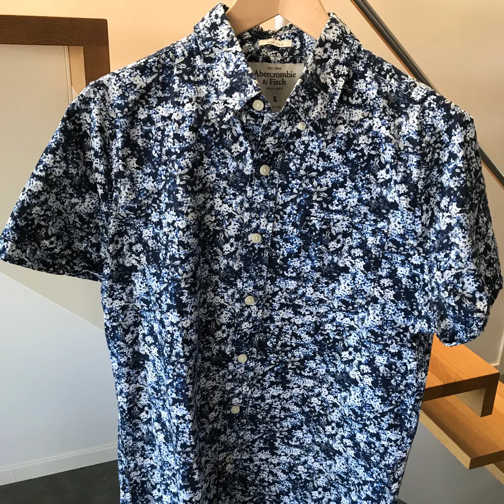 Kortärmad skjorta från Abercrombie & Fitch blå med blommönster storlek S. Skjortor.