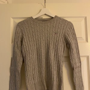 Gant tröja  - Kabelstickad grå tröja från Gant storlek Small, använt endast 1 gång så väldigt bra skick. Fraktkostnad tillkommer