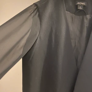 Svart mesh kavaj - Svart kavaj med mesh armar från monki. Inte använt för att den är för liten.