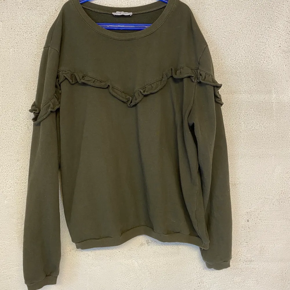 Mörkgrön sweatshirt med volang detaljer. Fint skick i storlek M. Köparen står för frakt.. Tröjor & Koftor.