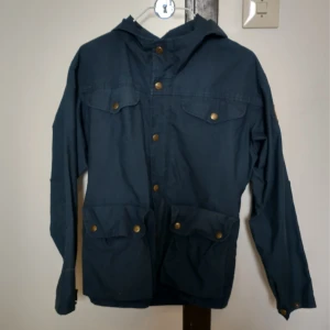 Fjällräven Jacka - Marinblå frilufts jacka från fjällräven. För barn. Minimalt slitage. Tvättas innan den skickas.