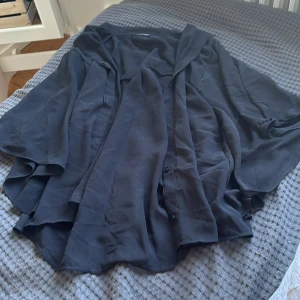 blus - fladdrig halvt genomskinlig svart blus. stora ärmar och perfekt för sommarkvällar 