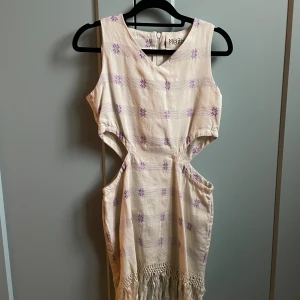 Mozh Mozh Woven Party Dress - Beautiful Woven Dress with Purple Flower Details by Peruvian Designer Mozh Mozh  Features Cut out Sides and Fringed Hem  Excellent Condition  Best Fits XS