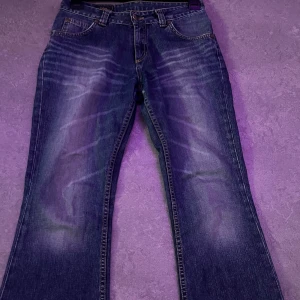 Lågmidjade bootcut jeans ifrån märket Lee - De är i bra skick, De är i storlek 38 men sitter som en storlek S, jag säljer dessa pga de var för små. De är köpa på vinted och aldrig använda av mig. De är uppklippta men passar perfekt om man är runt 165-170, jättelitet hål (syns på sista bild) 