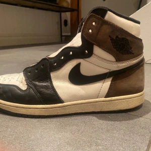 Jordan 1 mocha - Säljer ett par Jordan 1 mocka eftersom dom inte kommer till någon användning det finns några slitningar som tillexempel det man ser på sista bilden som går säkert att fixa själv eller skomakare. Är köpta begagnade så vet ej om de är äkta