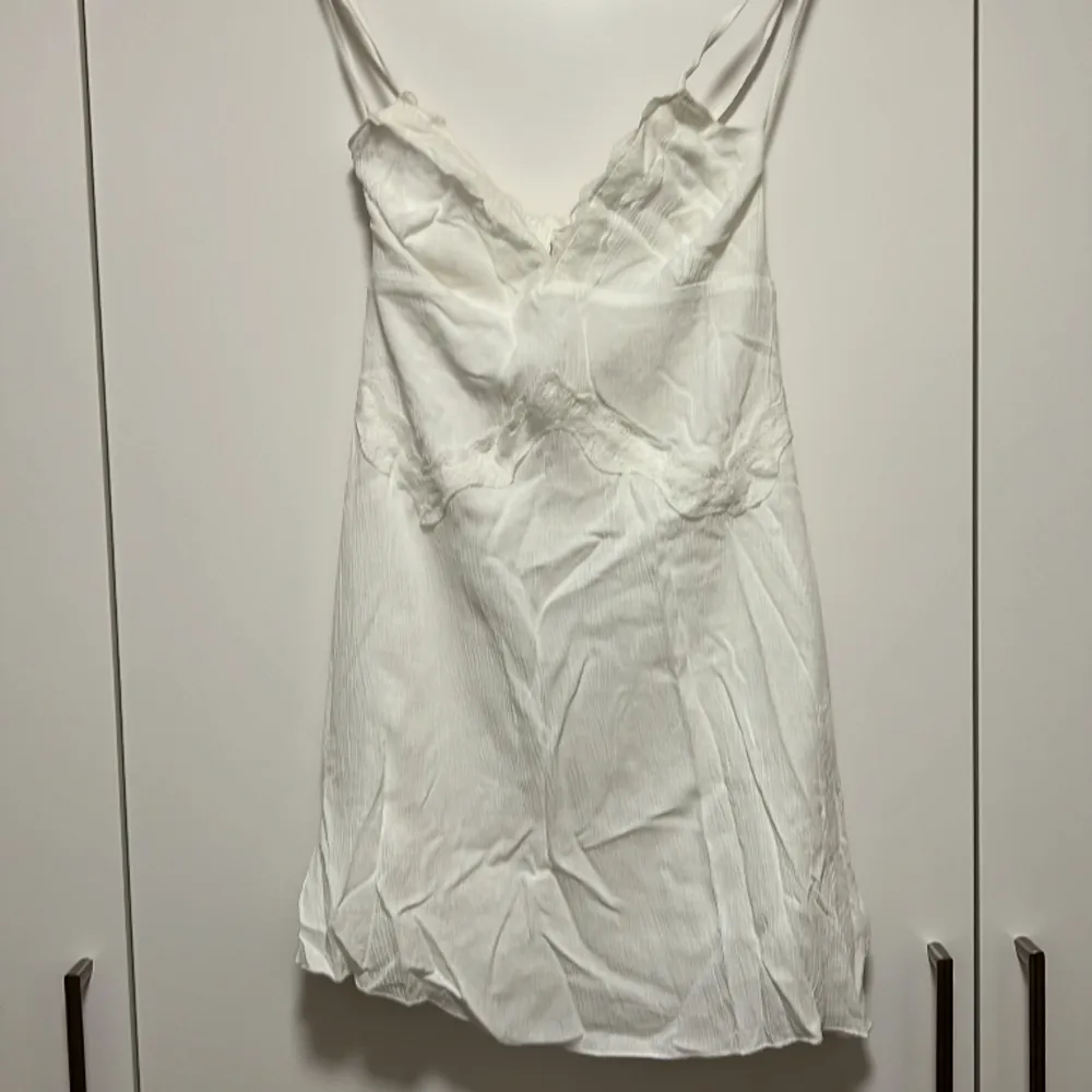 Söt klänning från Stradivarius med korsad rygg och knytdetalj. Aldrig använd då den är för kort för mig (170 cm). Klänningar.
