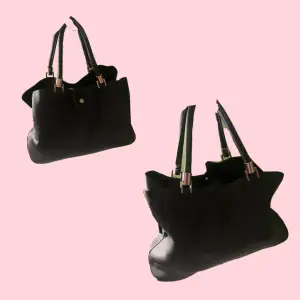 En jättefin stilren svart väska med stora fack. Den är väldigt rymlig och har mycket plats. 🎀   