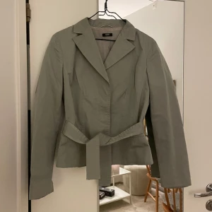 Kavaj Hugo Boss - Kavaj från Hugo Boss i grå färg! Så snygg passform. Väl använd men inga märkbara defekter💗 står strl 38, men den passar strl 36! Avtagbart band.