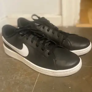 Black Nike shoes with the white Nike logo 