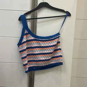 One-shoulder Stickad topp - Somrig, one-shoulder stickad topp i storlek S som går ner till naveln på mig 🥰(är 163)  Säljer då den är lite för stor 💕Helt i nyskick, aldrig använd!  Skriv privat vid fler frågor 🥰