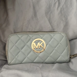 Michael Kors plånbok  - Jätte fin plånbok men dragkedjan är lite slö vid en vis del på plånboken. De har lite repor på själva MK märket där av priset.