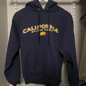 Mörblå hoodie med ”California Golden Bears” tryck. Storlek S!