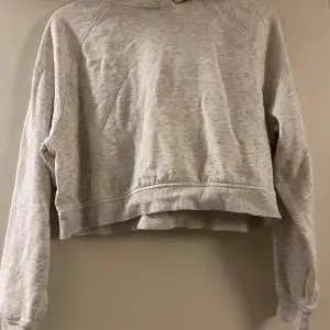 Säljer denna gråa croppade hoodie från H&M i storlek XS. Använd ett fåtal gånger så den är i bra skick.   Tvättas innan frakt 🩶 Köparen står för frakten! Nypris: 200 kr