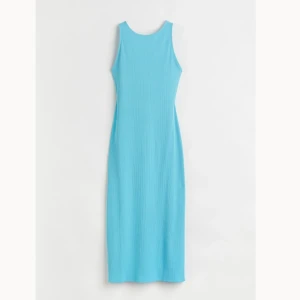 Ribbad Klänning  - Helt oanvänd klänning men prislapp kvar som bara legat i min garderob sen jag köpte den. Stretchigt och mjukt material och har en fin rygg. Klänningen går ner till vaderna och har en slit. Storlek S men passar även M.