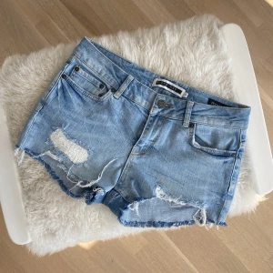 Lågmidjade jeansshorts  - Lågmidjade jeansshorts med snygga detalj slitningar ❤️‍🔥 storlek 25, passar allt från XS till en mindre M. Fint skick, köparen står för frakten. Bara höra av sig med frågor 💞