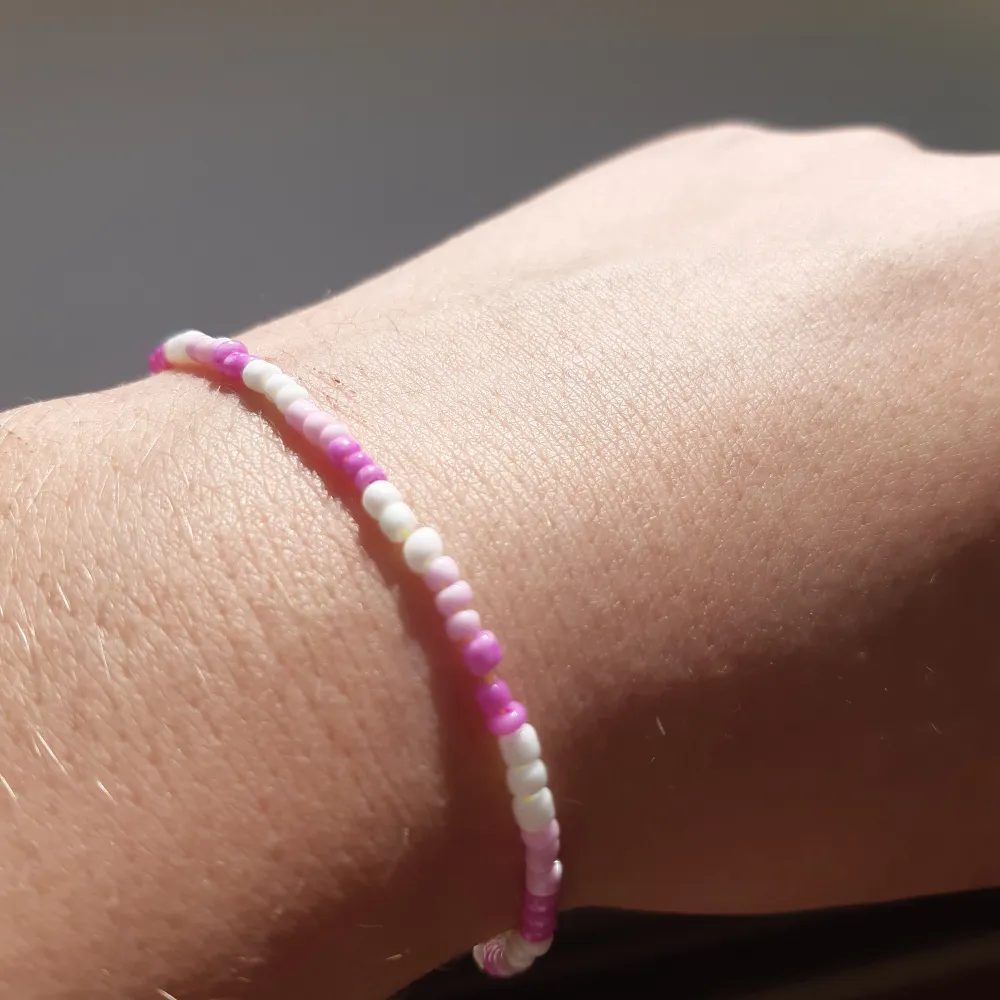 Ett armband med små rosa, vita pärlor. Tips var försiktig det KAN kanske gå sönder!🤗. Accessoarer.