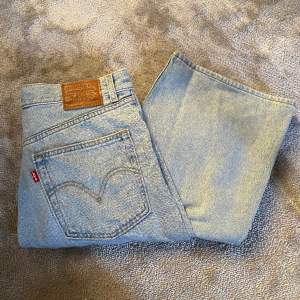 Levi's jeans använda fåtal ggr. Ljusblå med långa vida ben och hög midja. 