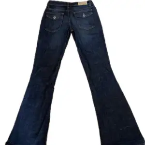 Lågmidjade mörkblåa Bootcut jeans från märket Arizona. De har knappar på fickorna❣️jag är 164 och de passar men är lite långa. 