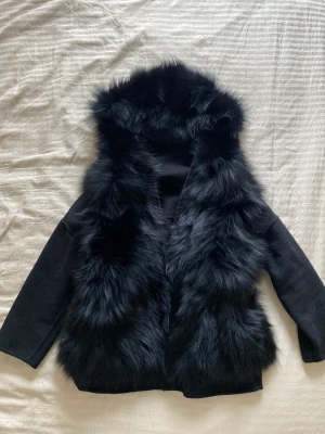 Pälsjacka custommade liknade  - Snygg pälsjacka i tvättbjörns päls. Man kan vända den in o ut och även ta bort pälsen och ha den som en väst storlek S oversized fint skick 