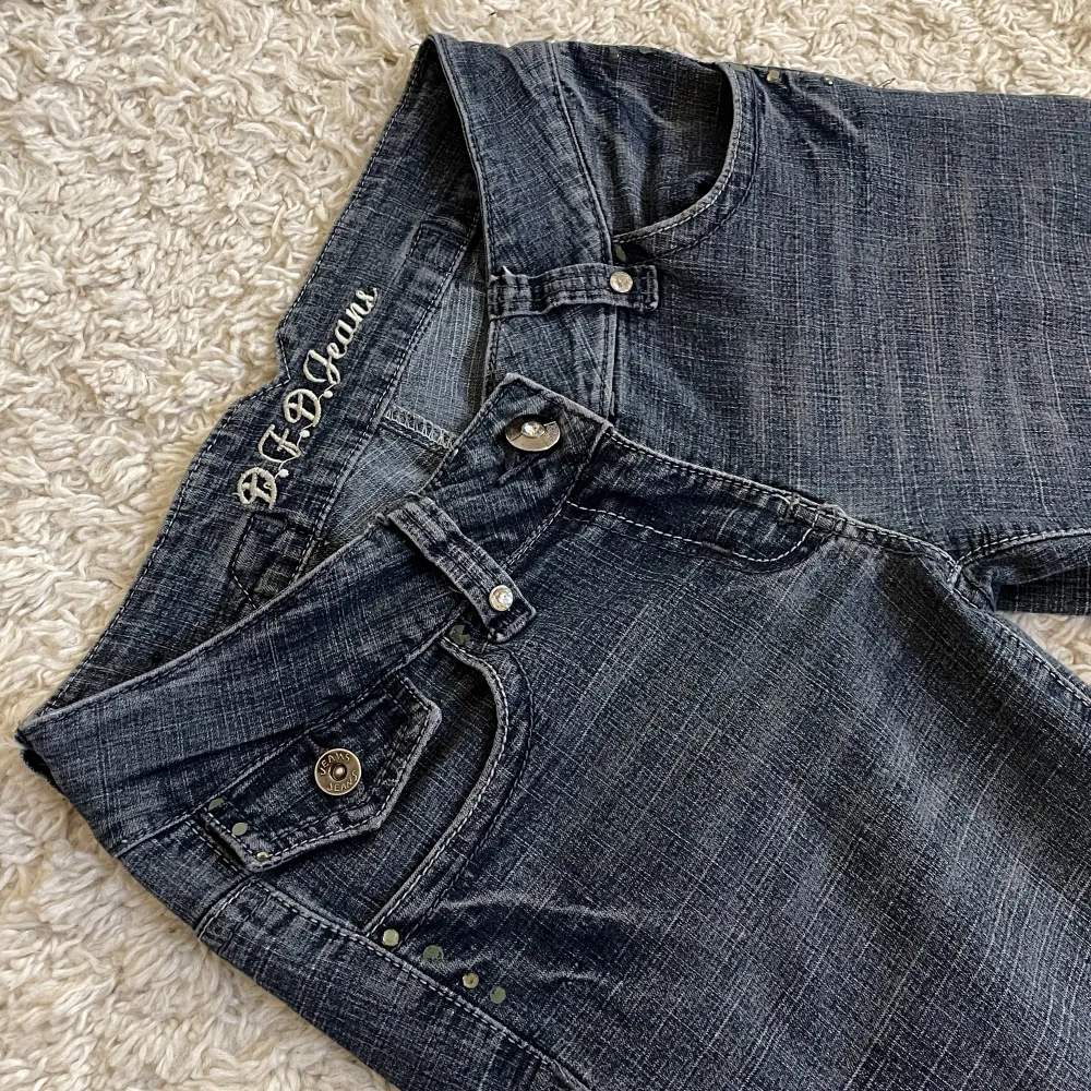 Rhinestones både bak och fram (en del har lossnat) och assnyggt spänne! ❤️Bootcut och lågmidjad modell, gråblå färg. 🫶Innerben: 76cm, midja rakt över: 33cm. Stretchiga!! Jag är 165, kan fixa fler mått. 🥰 Håll koll på min profil, lägger upp vintage jeans. 😍. Jeans & Byxor.