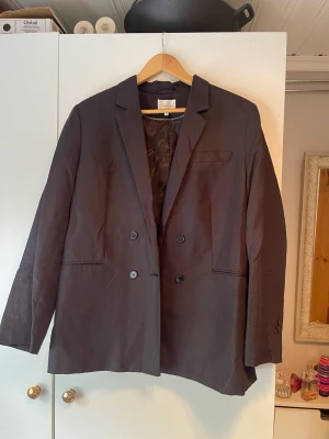 Kavaj - En svart kavaj. Storlek: 44. 