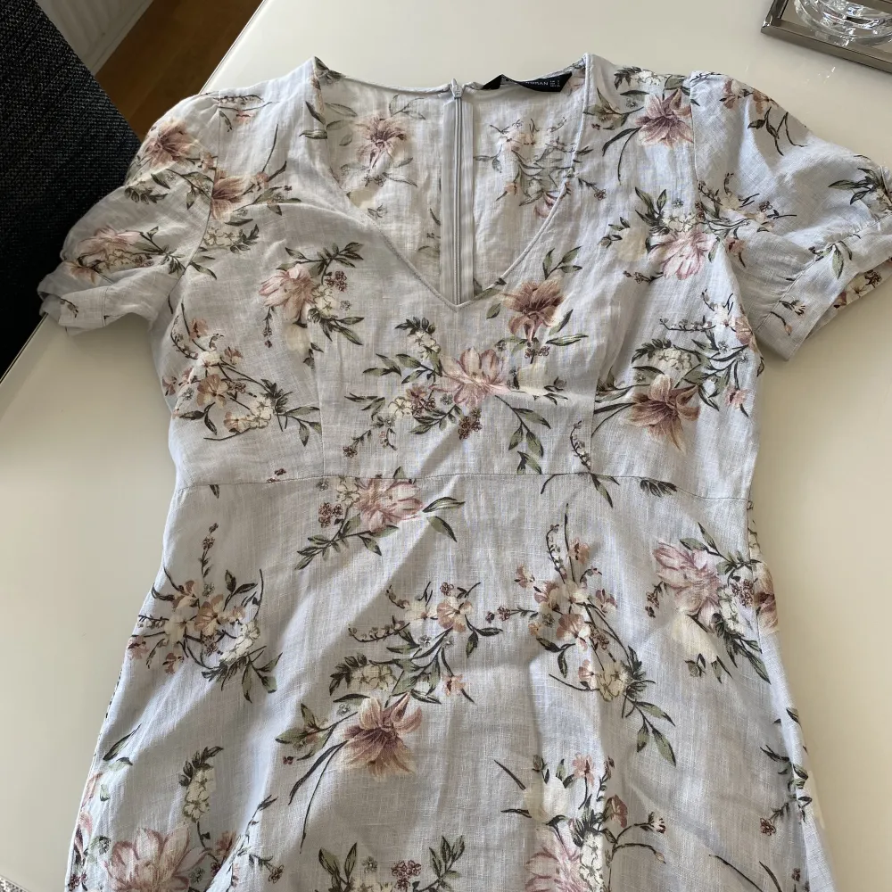 Säljer denna blommiga klänning i linnetyg från Zara. Färgen är en väldigt ljus blå. Använd någon/några gånger. (Storlek S men sitter lite ”luftigt” på mig som normalt har S så den hade nog passat en M också beroende på hur man vill att den ska sitta). Mekot.