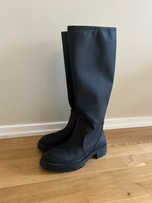 Zara boots  - Säljer ett par höga svarta boots från Zara. Använda endast ett par gånger. Har några små repor på ena stöveln (syns på bild 3) men annars inga defekter. Nypris 599kr. 