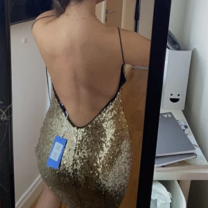 Glittrig klänning med öppen rygg - Säljer denna helt oanvända klänning jag köpt på sellpy för 800💗Så fin och framhäver verkligen ens kurvor🙌🏻