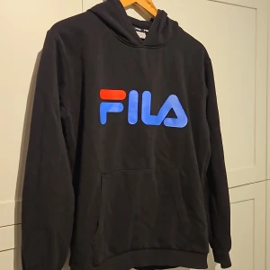 Svart Fila hoodie stl. 170/176 eller small - En svart Fila hoodie som är i barnstorlek 170/176 men kan också användas som en small. Den är i bra skick.