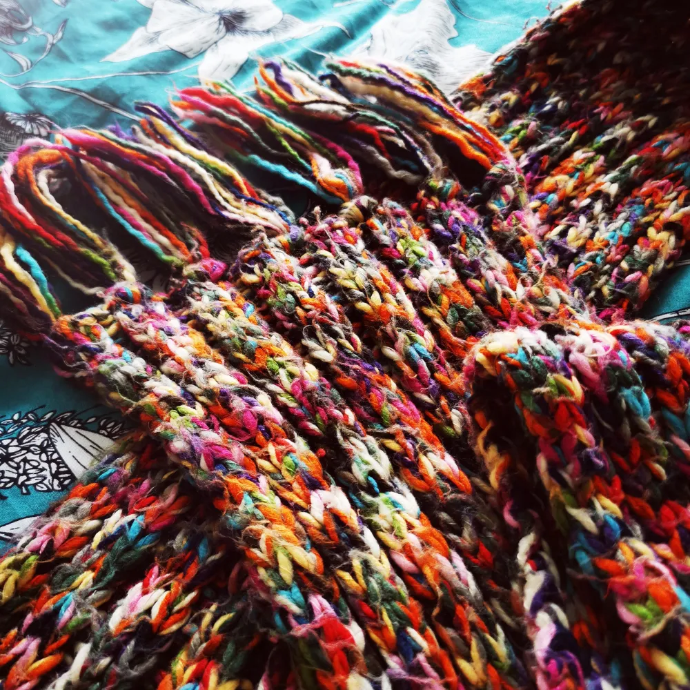 Multicolored scarf. Hand knitted. Signs of wear but still in good condition . Övrigt.