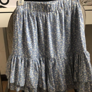 Blommig blå kjol  - En fin blommig blå kjol i storlek xs men passar oxå s. 