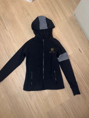 Maya Delorez hoodie - Grå Svart Maya Delorez hoodie/ridnings hoodie. Mycket bra skick, Inte så använd. Storlek XS. Köpt för ungefär 900kr, säljer här för 350😃Skriv om intresse finns!