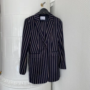 Kostymset  - Tvådelat Kostymset från NA-KD, storlek 38 i byxorna och storlek 36 i kavajen. Allt är i nyskick och endast användt 1 gång. Jättefin kvalitet och snyggt pinstriped mönster + slits nedtill på byxorna! 💙