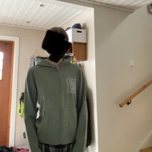 Grön zip hoodie  - Grön zip hoodie från XOXO friends🙌🏼Använd ca 2 gånger och har flera små fläckar på baksidan längs ner på mudden. Strl. 170 men passar som XS, beroende på hur du vill att den ska sitta💕