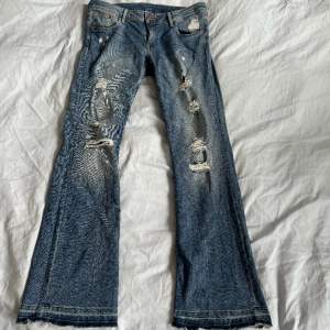 lågmidjade jeans med hål köpta här på plick! midjemått: 42cm innerbenslängd: 80cm