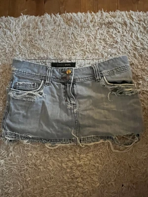 Blå jeanskjol med slitna detaljer - Supersnygg jeanskjol med mycket slitningar