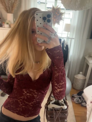 Vinröd spetsblus med v-ringning - Säljer en vinröd långärmad spetsblus från Gina Tricot. Blusen har v-ringning, är genombruten med blommigt spetsmönster och är figurnära i modellen. Perfekt att styla med jeans eller kjol för en snygg look. Andvänd ca 1-2 ggr.