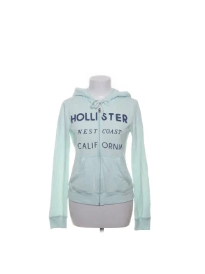 Ljusblå Hollister hoodie - Ljusblå hoodie från Hollister med dragkedja framtill
