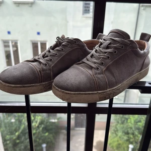 Grå louboutins - Snygga louboutins i grå mocka med klassisk snörning och rund tå. Skorna har en platt sula och stilren design som passar till det mesta. Perfekta för dig som gillar en enkel men trendig look. Passar storlek 44. Dustbag, box och kvitto följer med.