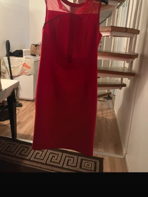 Red Sleeveless Dress with Mesh Details – Orsay - Elegant red dress from Orsay, perfect for parties, dinners, or special occasions. The dress has a clean, straight fit with beautiful sheer mesh details at the neckline, giving it a classy and feminine look. Comfortable to wear and easy to style with heels or flats. Brand: Orsay Color: Red Style: Sleeveless / knee-length Details: Mesh / sheer neckline Condition: Very good condition (no visible flaws) A timeless piece that works for both casual and dressy events. 