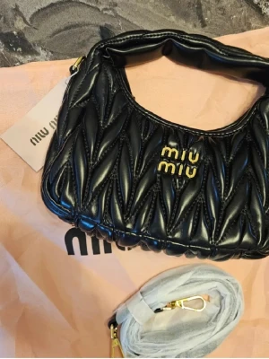 Svart quiltad handväska från Miu Miu - Ni vet varför det är billigt!                              Fast pris, då det redan är billigt. Först till kvarn. Axelrem ingår.