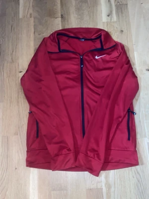 Röd Långärmad Nike Kofta - En fin Röd Långärmad Nike Kofta som är i extremt bra skick, om du har några frågor så är det bara att skriva till mig. Tack Mvh 😊