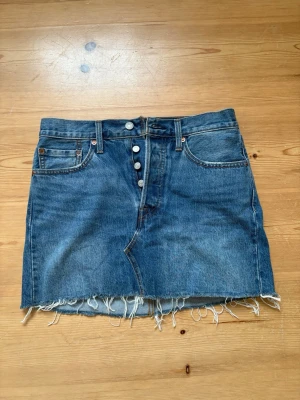 Levi's jeanskjol  - Säljer en klassisk blå jeanskjol från Levi's. I storlek 27